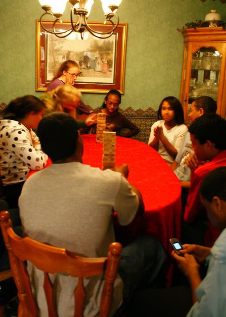 A group of young people playing two sets of jenga
